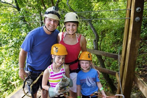 Caucasian family ready to zip line in Costa Rica